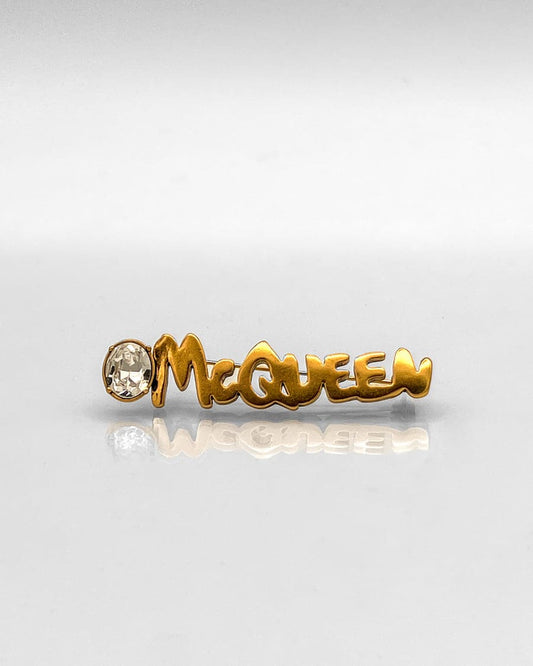 Alexander McQueen logo lapel pin brass Swarovski crystal