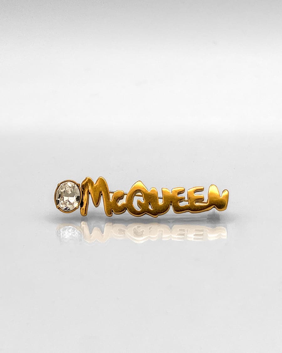 Alexander McQueen logo lapel pin brass Swarovski crystal